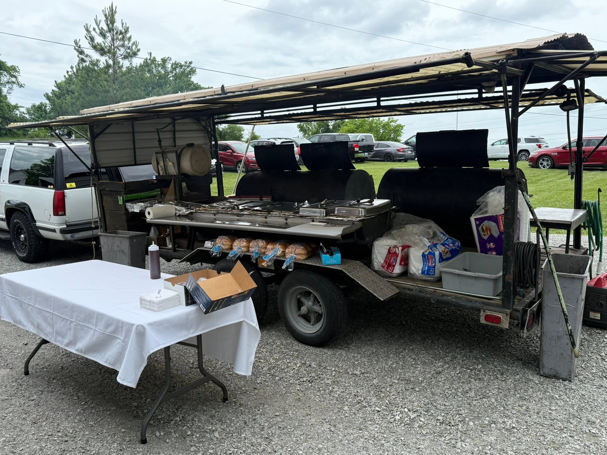 Kinnard Brothers BBQ smoker trailer set up at an event